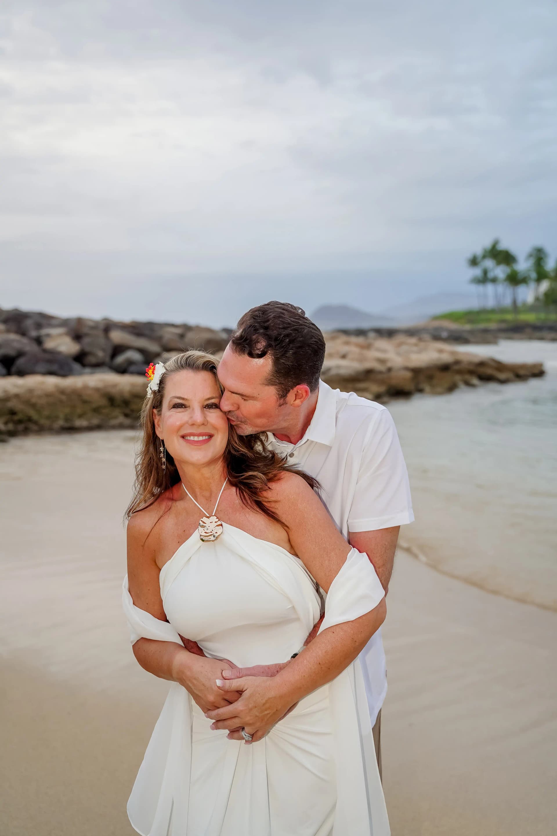 Mature couple embracing on the beach with tender moment